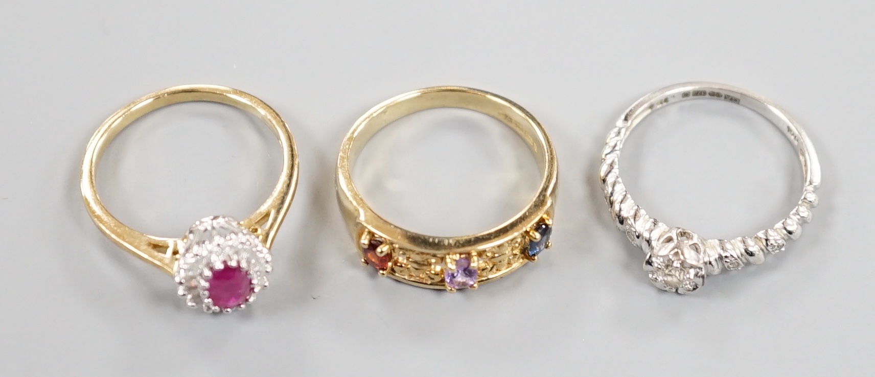 Three assorted modern 9ct gold and gem set dress rings, gross weight 8.6 grams.